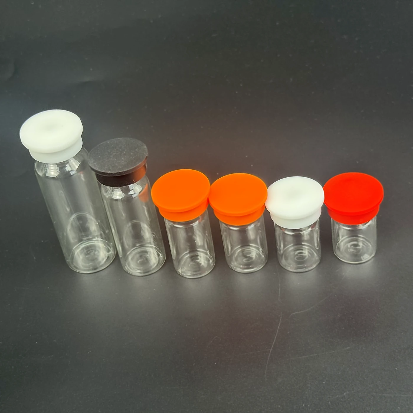 opened 5ml vials with different color silicone caps for color coding